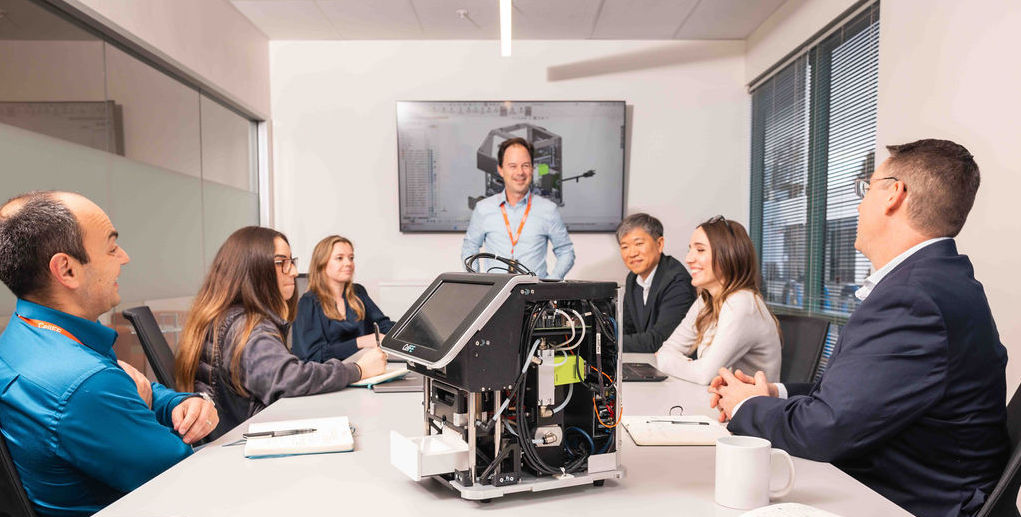 Team sitting together and looking at new technology