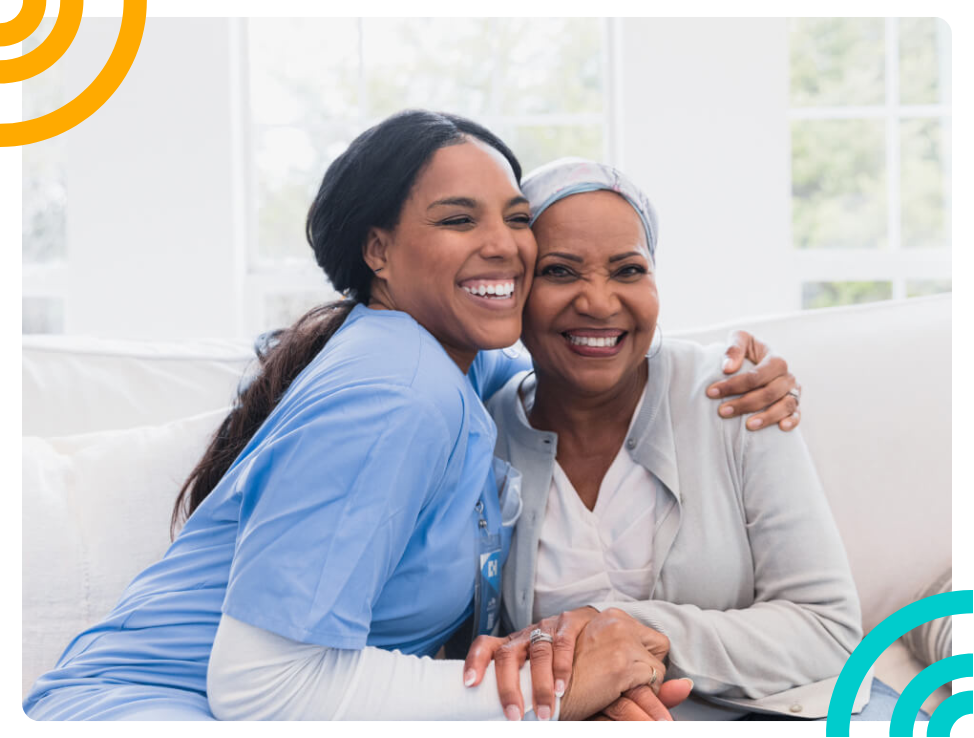 woman in scrubs and patient hugging